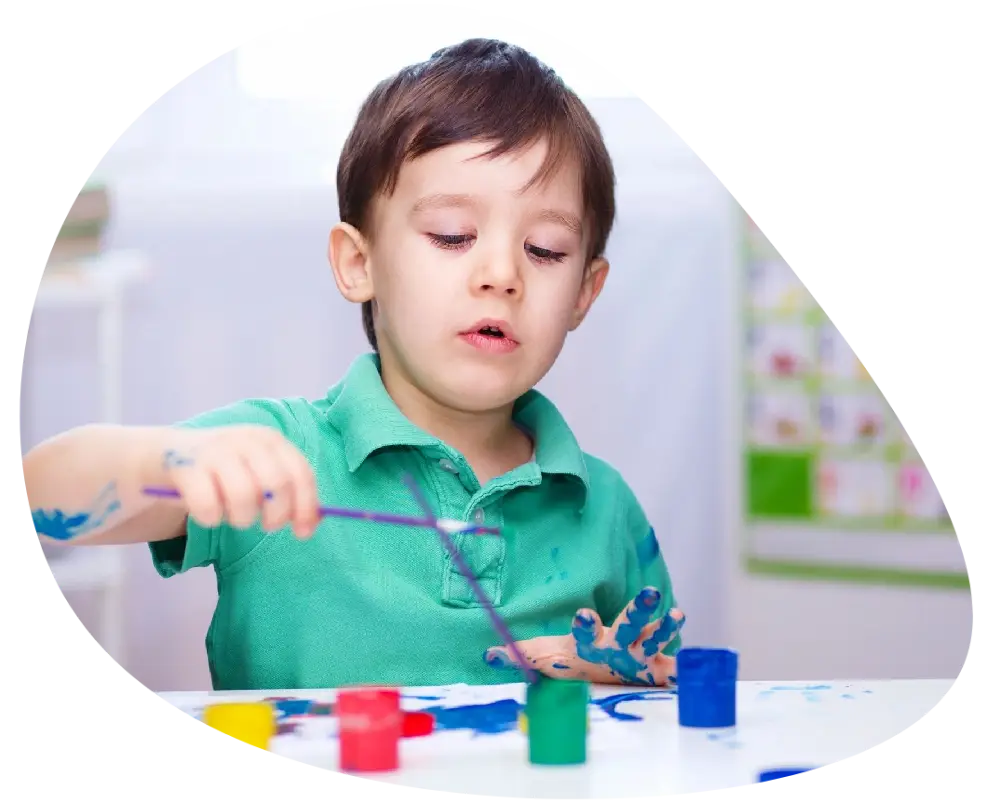 a kid playing with paints a kid playing with paints